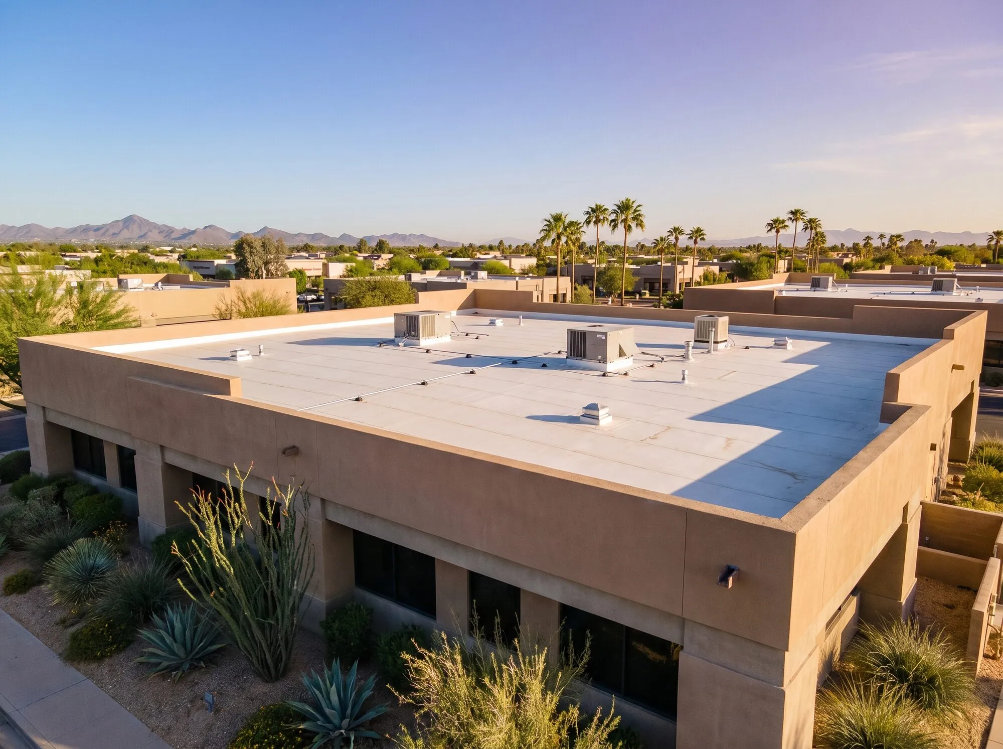VRZA commercial roofing crew working on a flat membrane roof at an Arizona business